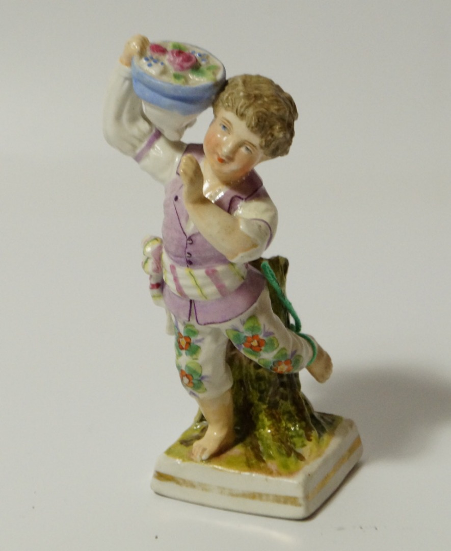 Appraisal: A thC Sitzendorf figure of a child holding basket of