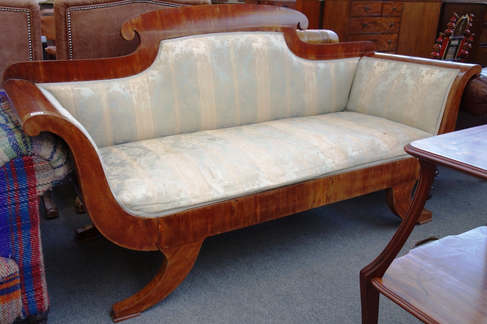 Appraisal: An early th century mahogany framed sofa with roll over