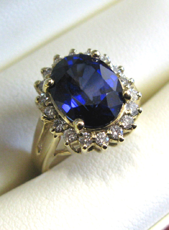 Appraisal: SAPPHIRE DIAMOND AND FOURTEEN KARAT GOLD RING centering an oval-cut