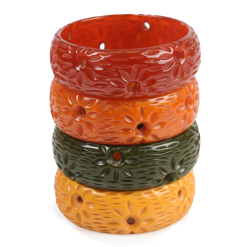 Appraisal: FOUR BAKELITE CARVED AND PIERCED BANGLE BRACELETS WITH SUNBURST DESIGNS