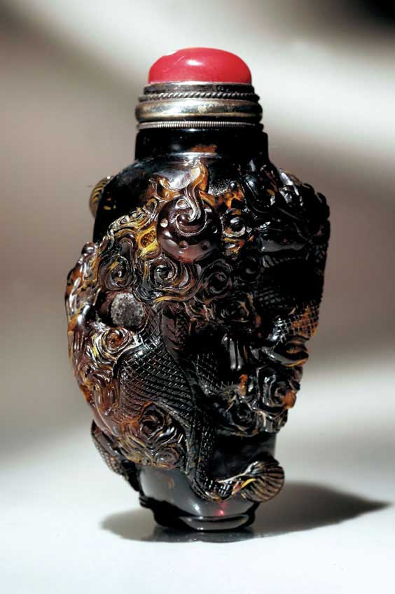 Appraisal: CARVED AMBER SNUFF BOTTLE Very elaborately carved and well hollowed