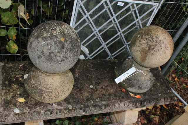 Appraisal: A PAIR OF OLD WEATHERED COMPOSITION GATE FINIALS of sphere