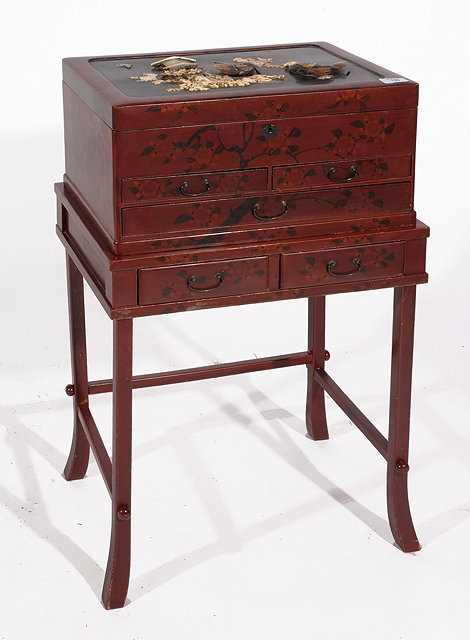 Appraisal: A JAPANESE LACQUER CASKET on a low stand the cover