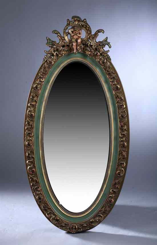 Appraisal: CONTINENTAL STYLE GILT AND GREEN-PAINTED OVAL MIRROR th century Crest