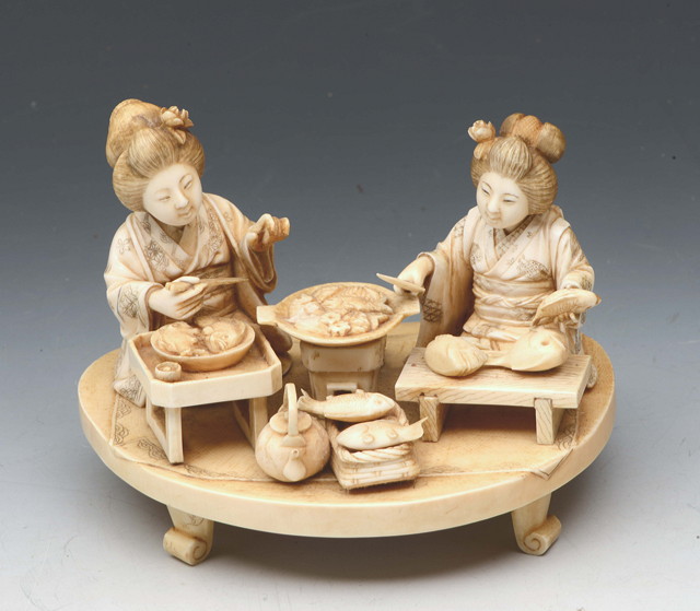 Appraisal: A JAPANESE IVORY CARVED GROUP OF TWO GEISHA arranging or