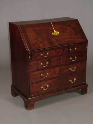 Appraisal: A George III mahogany slope front writing bureau enclosing fitted