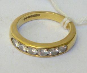 Appraisal: A DIAMOND SET HALF ETERNITY RING channel set with six