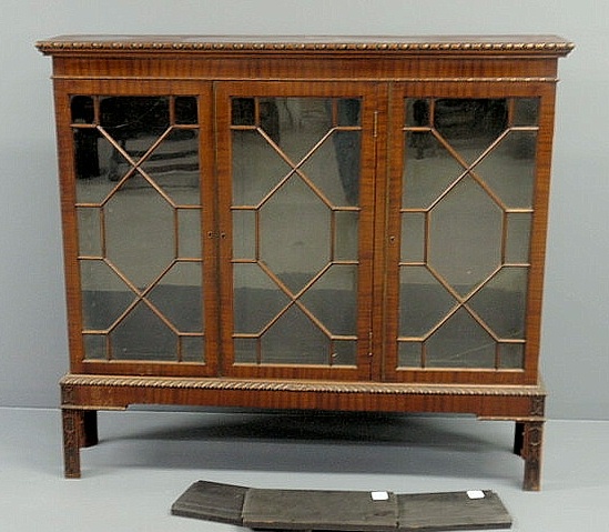 Appraisal: Chippendale style mahogany three-door bookcase resting on a frame with