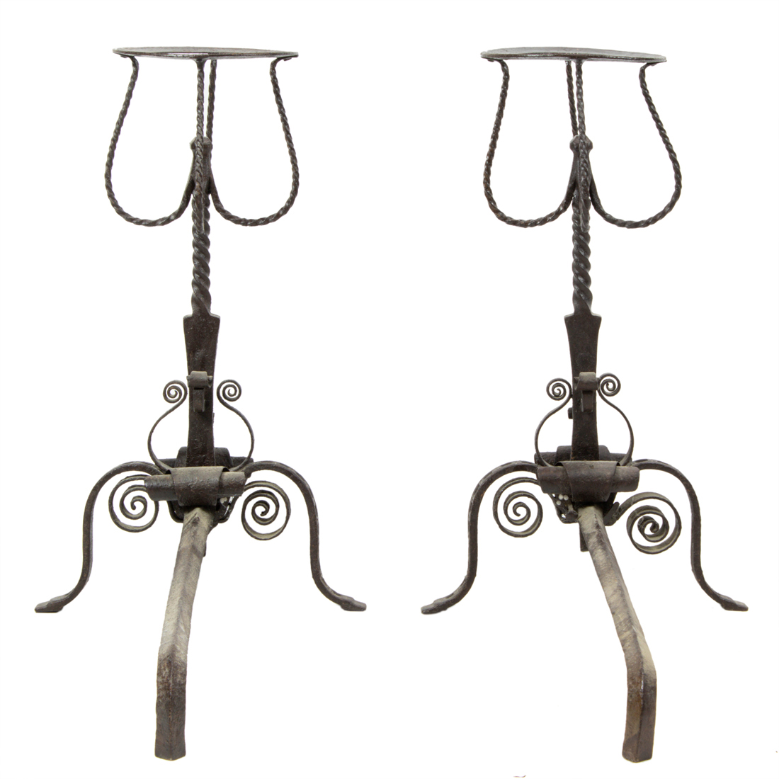 Appraisal: A pair of Spanish Baroque style wrought iron andirons th