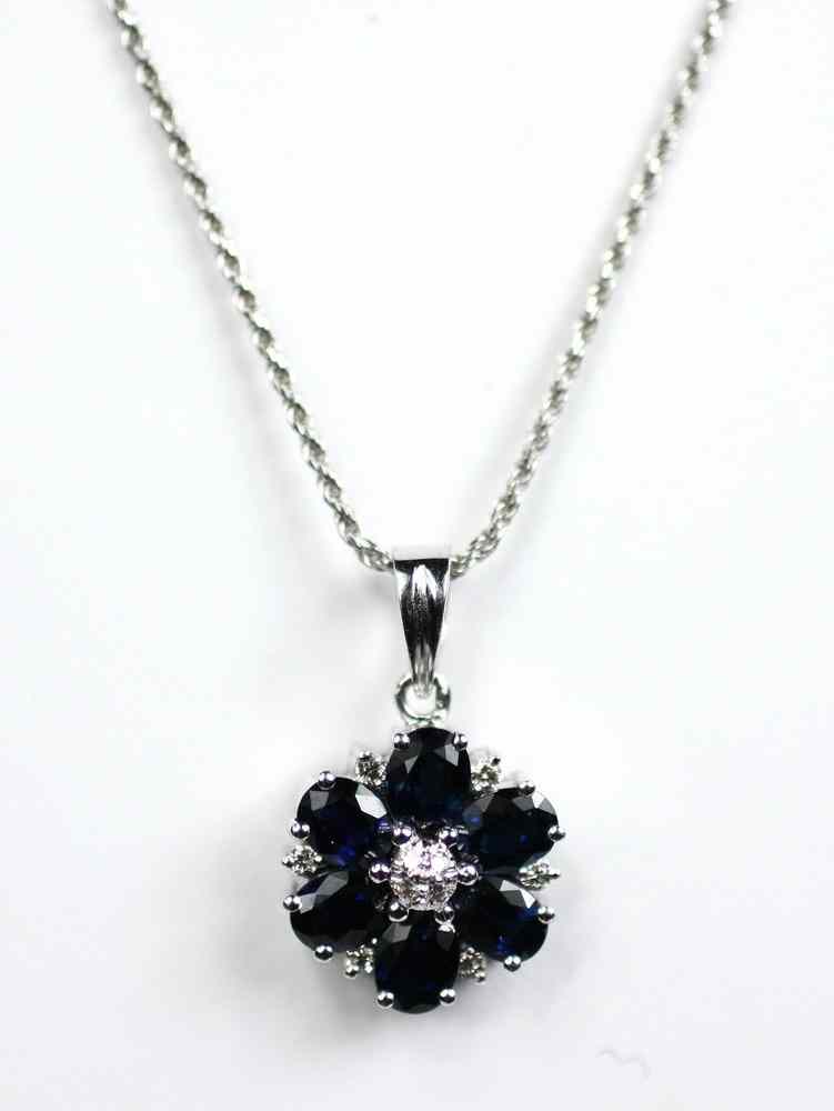 Appraisal: PENDANT - Flower form blue sapphire and diamond pendant set