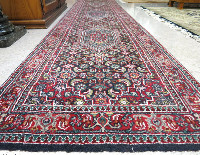 Appraisal: HAND KNOTTED ORIENTAL HALL RUG Indo-Bidjar featuring three hexagonal latch-hook