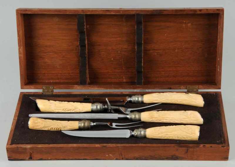 Appraisal: Carving Set with Carved Bone Handles Description Handles depict a