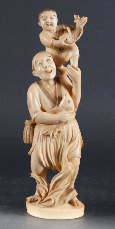 Appraisal: Japanese carved ivory figure of a fisherman and a boy