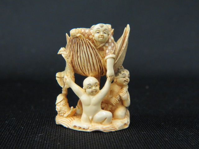 Appraisal: Carved Ivory Netsuke of Three Boysand a huge water hyacinth