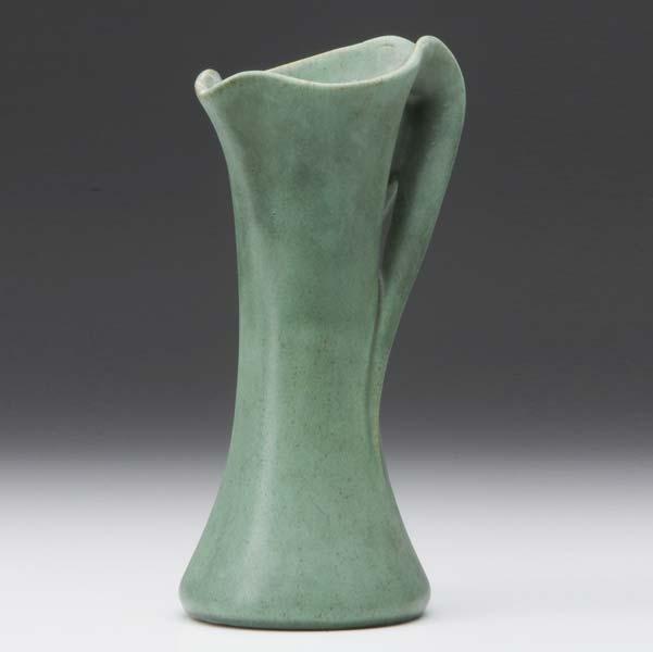 Appraisal: TECO Pitcher with whiplash handle covered in matte green glaze