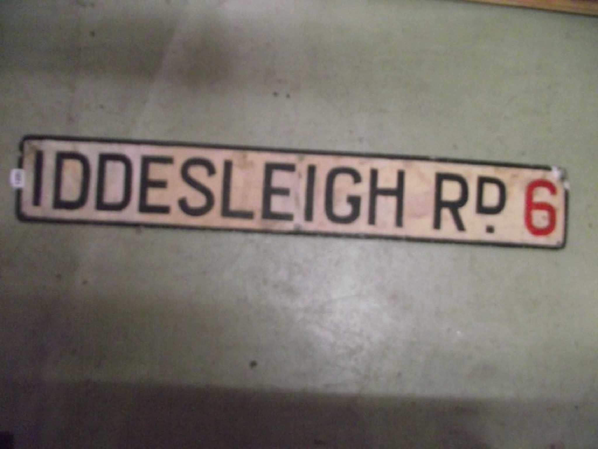 Appraisal: A reclaimed alumninium sign with raised lettering Iddesleigh Rd together