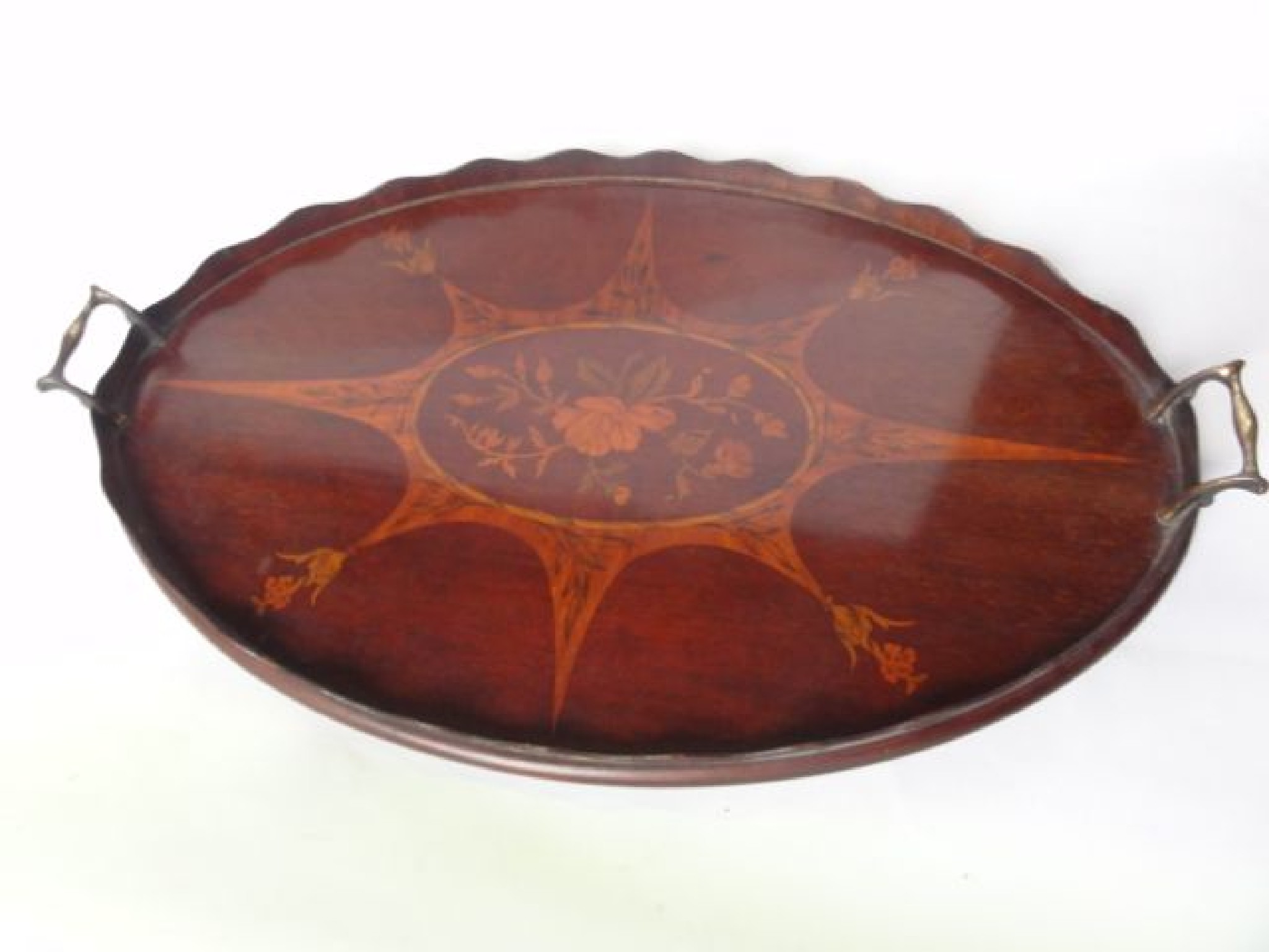 Appraisal: An Edwardian mahogany tray of oval form with extensive foliate