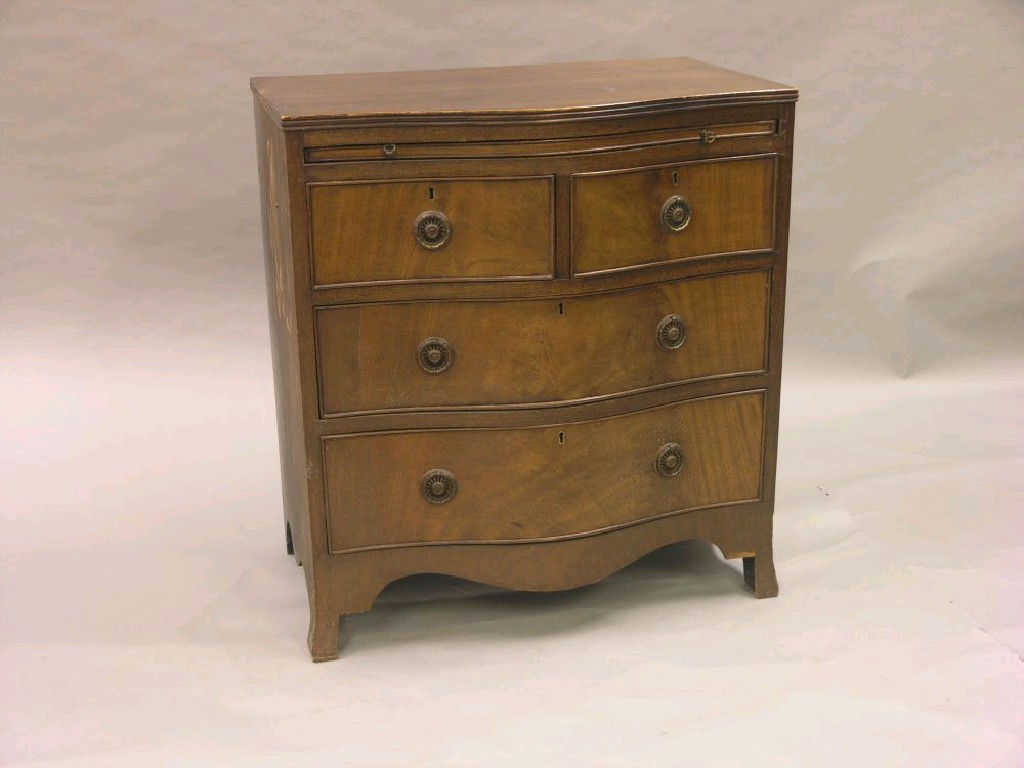 Appraisal: An early th century serpentine-fronted mahogany chest brushing slide above