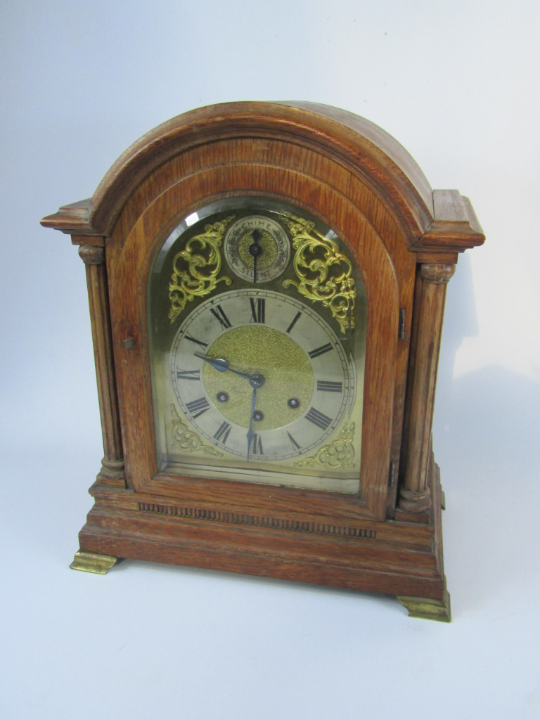 Appraisal: A Gustav Becker oak cased table clock of architectural form