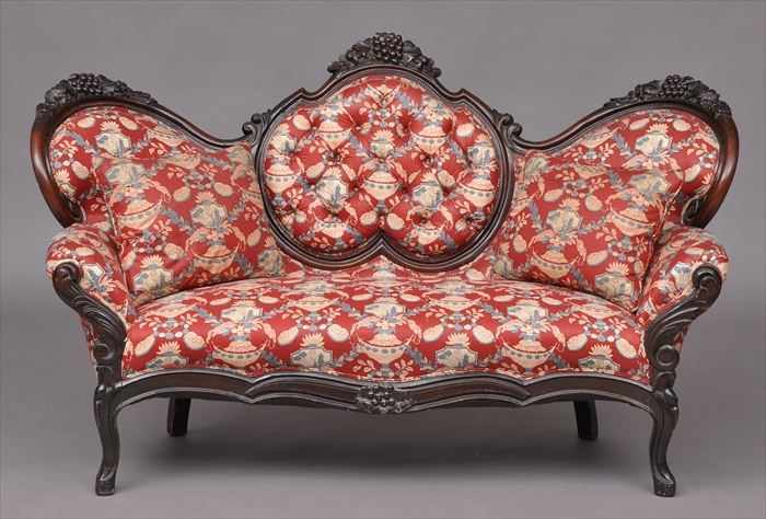 Appraisal: AMERICAN ROCOCO REVIVAL CARVED AND ROSEWOOD-GRAINED SOFA The grape-carved triple