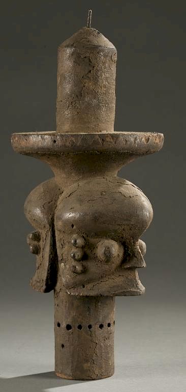 Appraisal: Ogoni cylindrical staff th c A cylindrical janus head staff