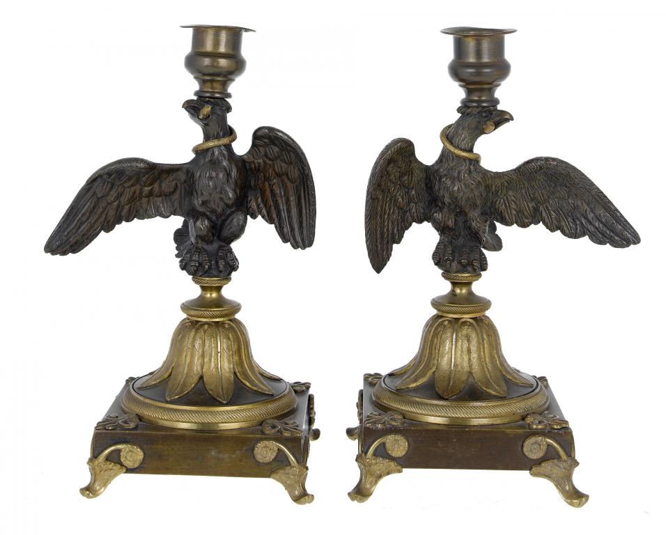 Appraisal: A PAIR OF NORTHERN EUROPEAN PATINATED BRONZE EAGLE-AND- SERPENT CANDLESTICKS