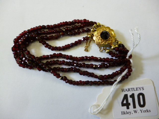 Appraisal: A GARNET BRACELET having four rows of faceted beads on