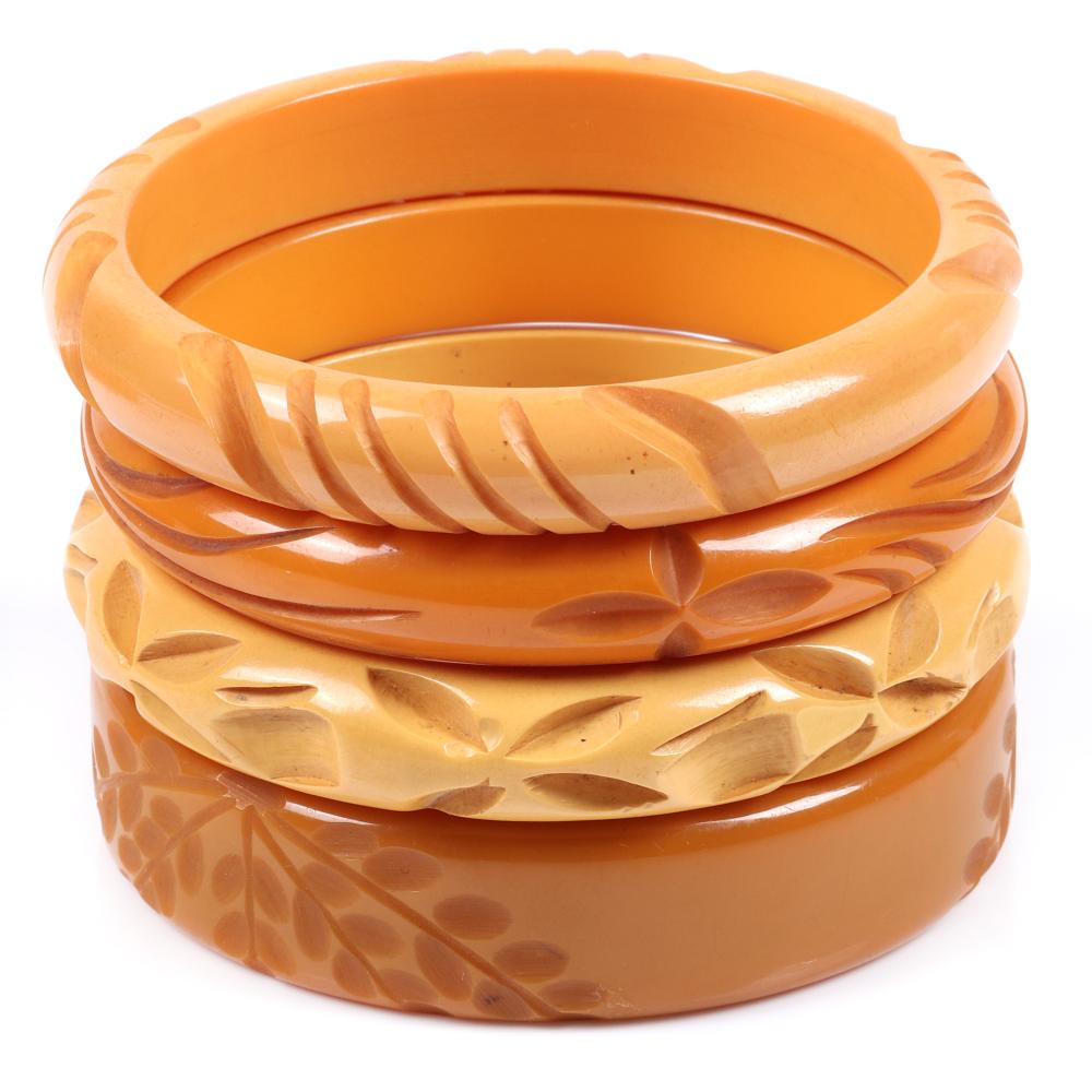 Appraisal: BAKELITE FOUR DEEPLY CARVED BUTTERSCOTCH BANGLE BRACELETS WITH VINE AND