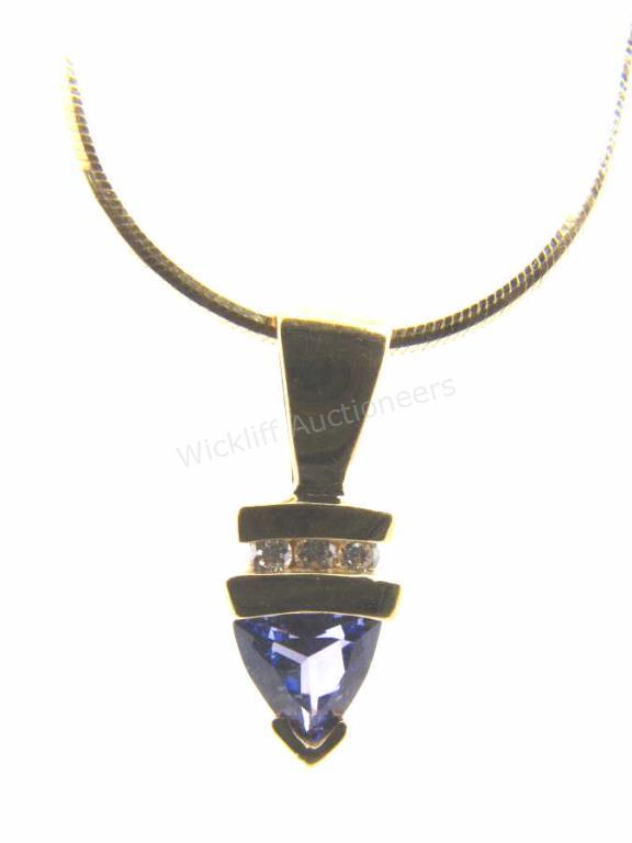 Appraisal: A K yellow gold pendant with a trillion shaped tanzanite