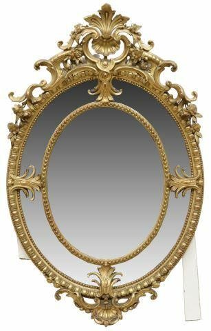 Appraisal: French giltwood framed oval wall mirror th c with shell