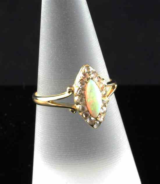 Appraisal: An Edwardian gold white opal and diamond marquise shaped cluster