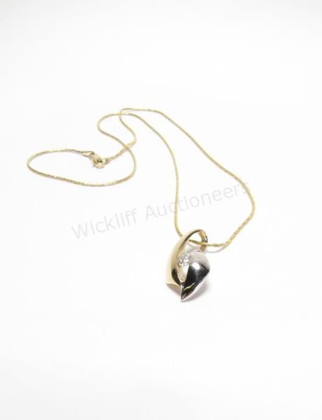 Appraisal: A K white and yellow gold contemporary design long pendant