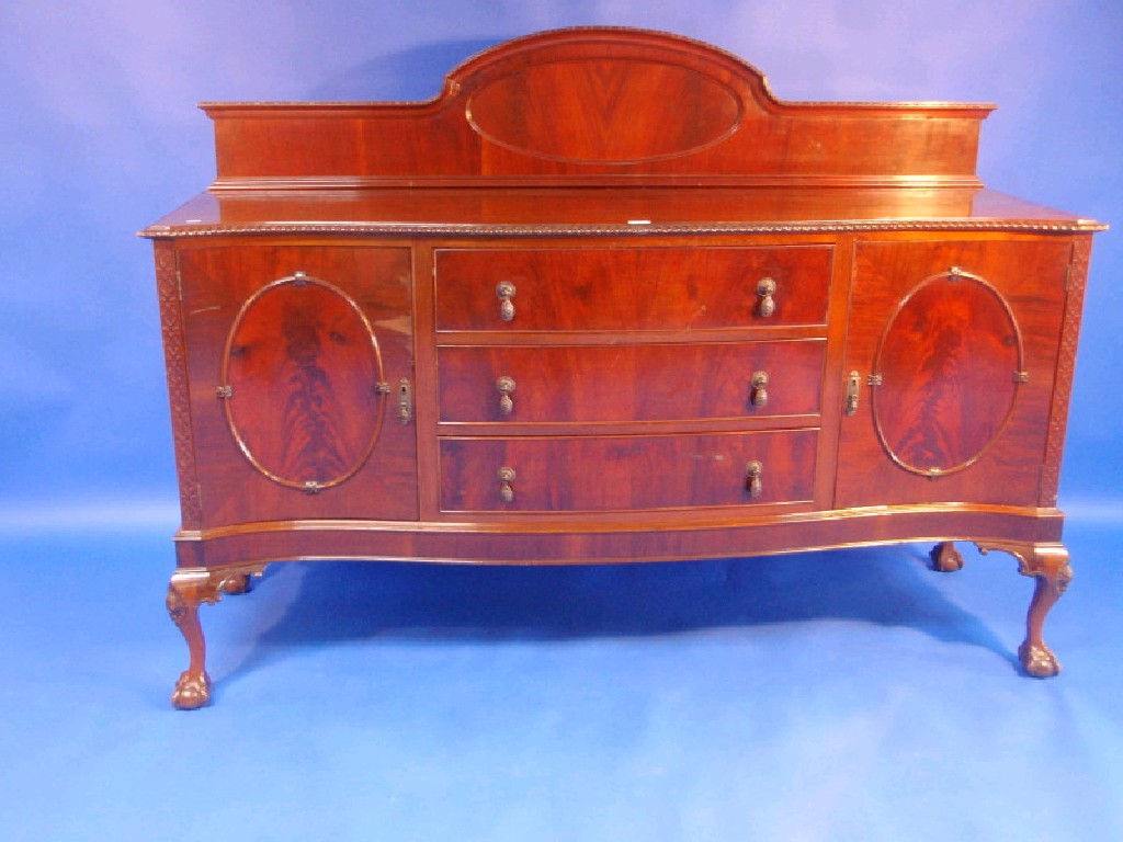 Appraisal: A 's mahogany serpentine sideboard with shaped back gadroon top