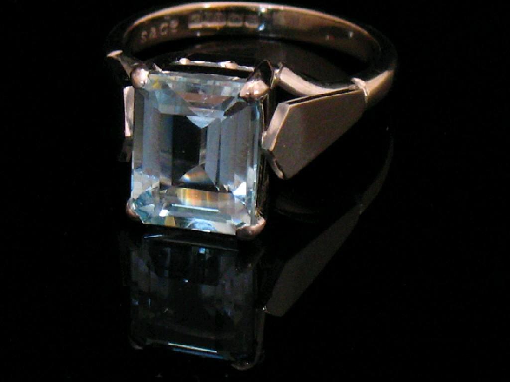 Appraisal: AN AQUAMARINE DRESS RING claw-set to the centre with an