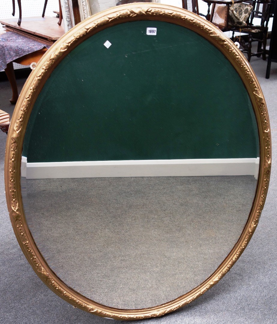 Appraisal: A late th century gilt framed oval wall mirror with