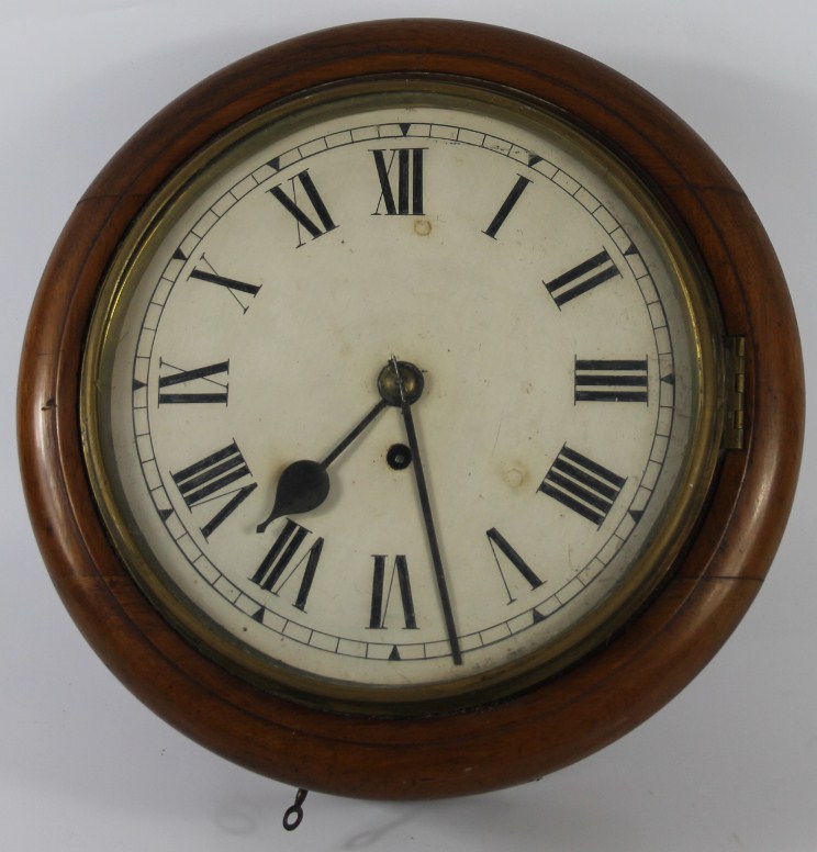 Appraisal: A Victorian circular wall clock with mahogany bezel and single