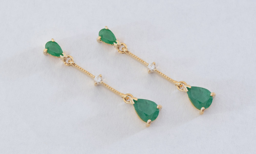 Appraisal: DIAMOND EMERALD DROP EARRINGS K yellow gold earrings contains round