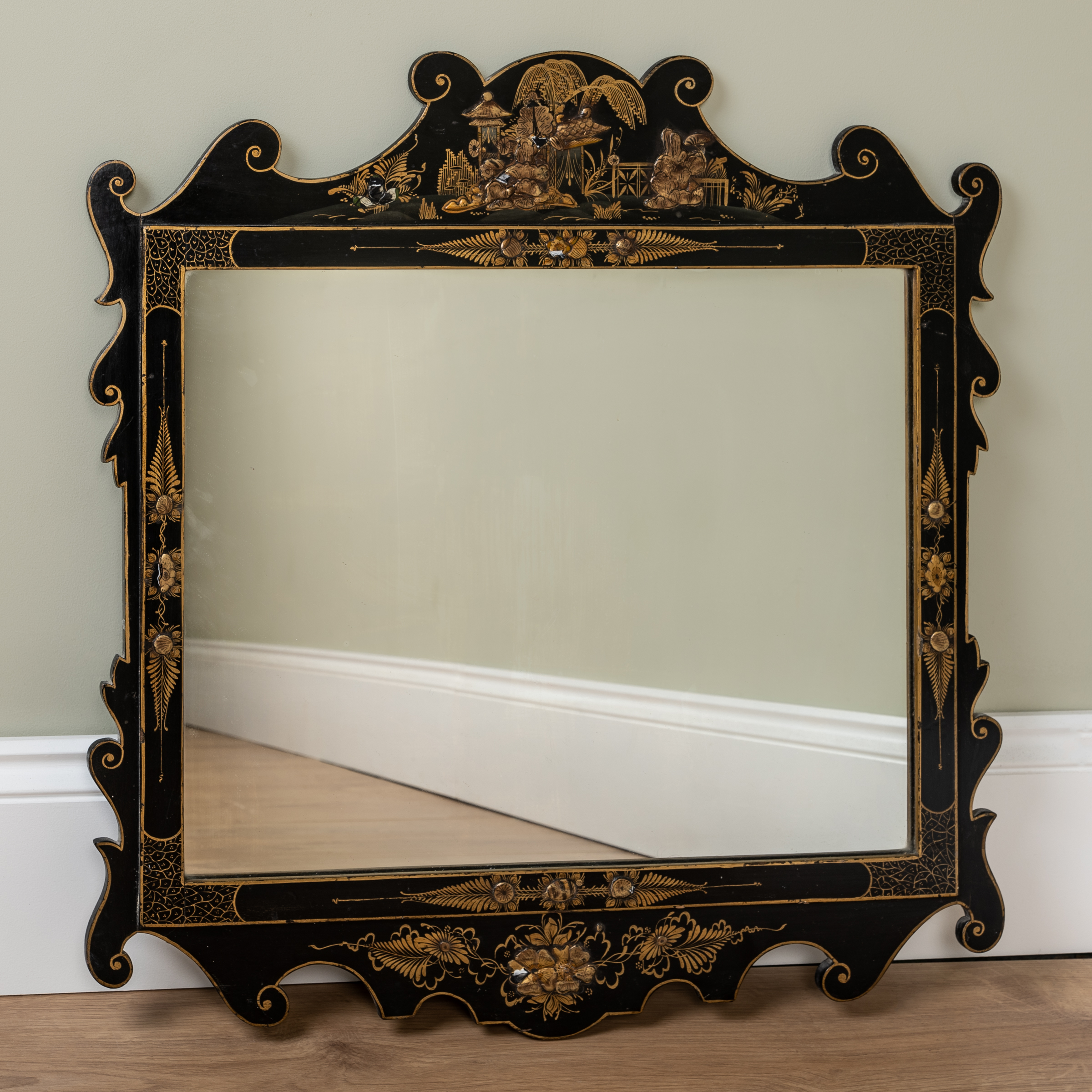 Appraisal: An Edwardian chinoiserie-style black lacquered fret framed wall mirror with