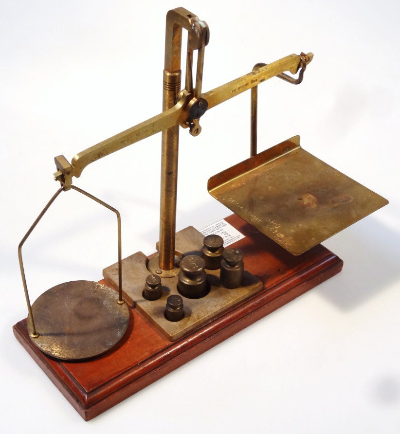 Appraisal: A miniature brass and wooden table scale square and circular