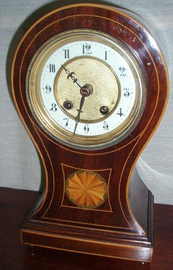 Appraisal: An Edwardian mantel clock of waisted form the circular dial