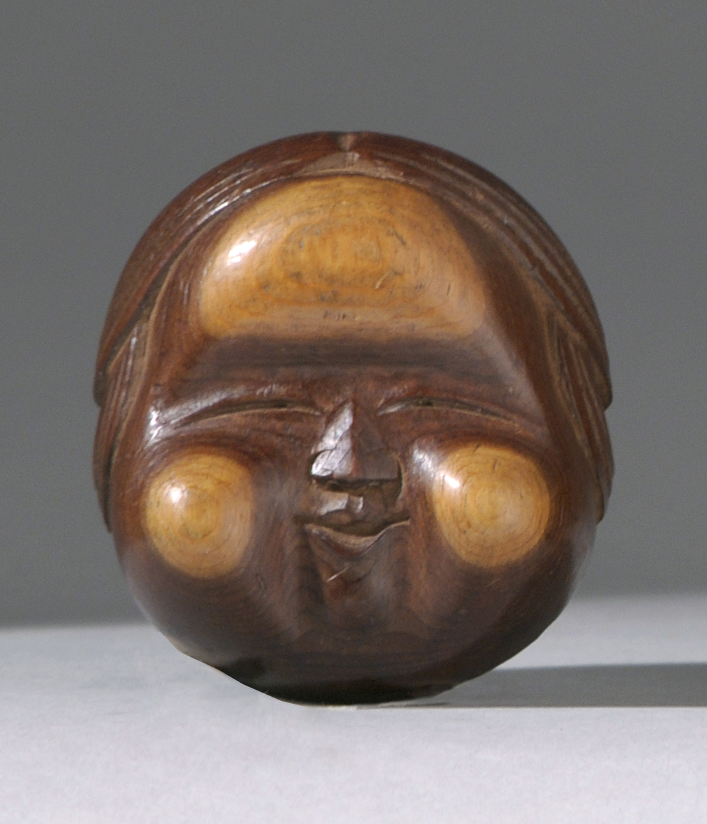 Appraisal: CARVED YEW WOOD ICHI NETSUKE th CenturyIn the form of