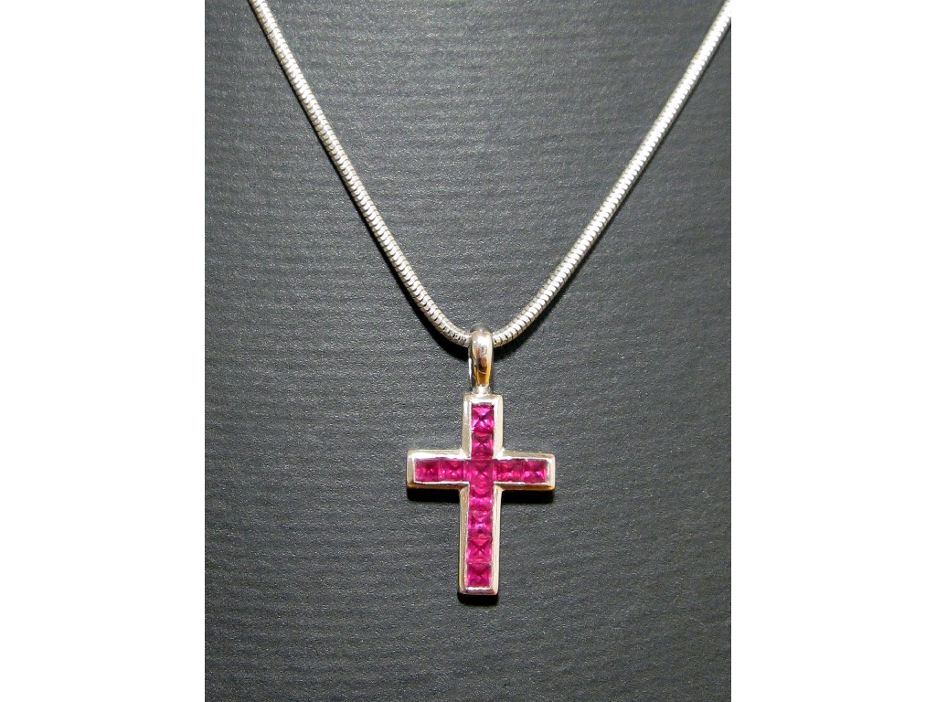 Appraisal: Eighteen carat white gold baguette cut ruby set cross pendant