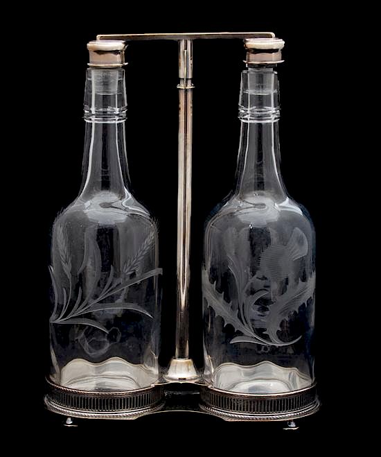 Appraisal: A Scottish Silver Plate Tantalus with Two Thistle Etched Bottles