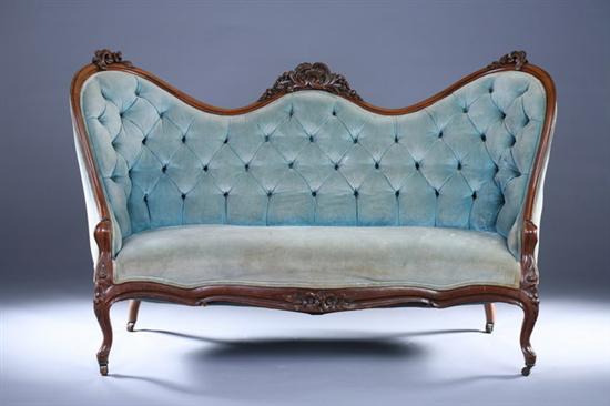 Appraisal: VICTORIAN ROCOCCO REVIVAL CARVED WALNUT SERPENTINE SOFA th Century Foliate