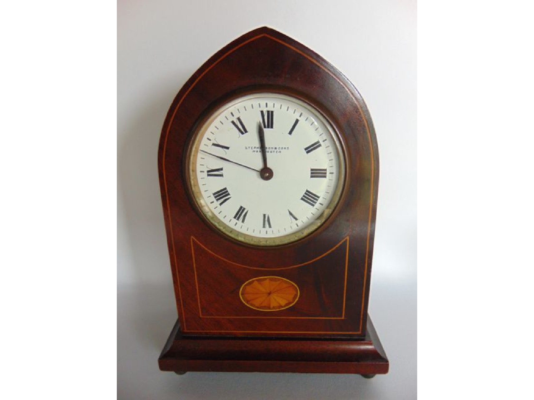 Appraisal: An Edwardian mahogany mantle clock with inlaid detail the lancet