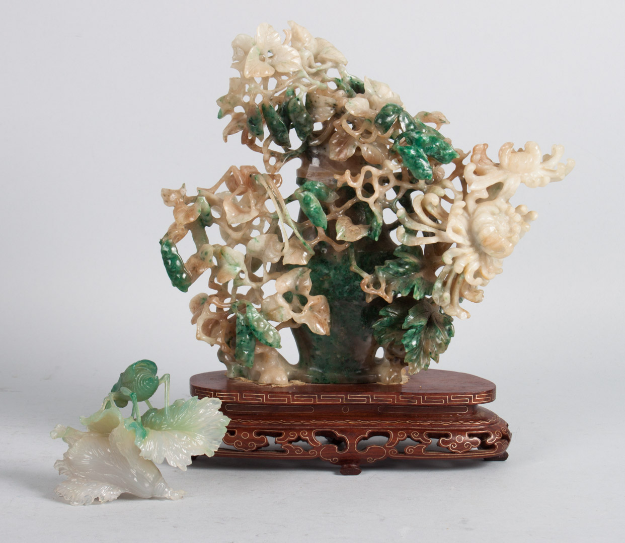 Appraisal: Two Chinese carved jade groups katydid on flower and urns