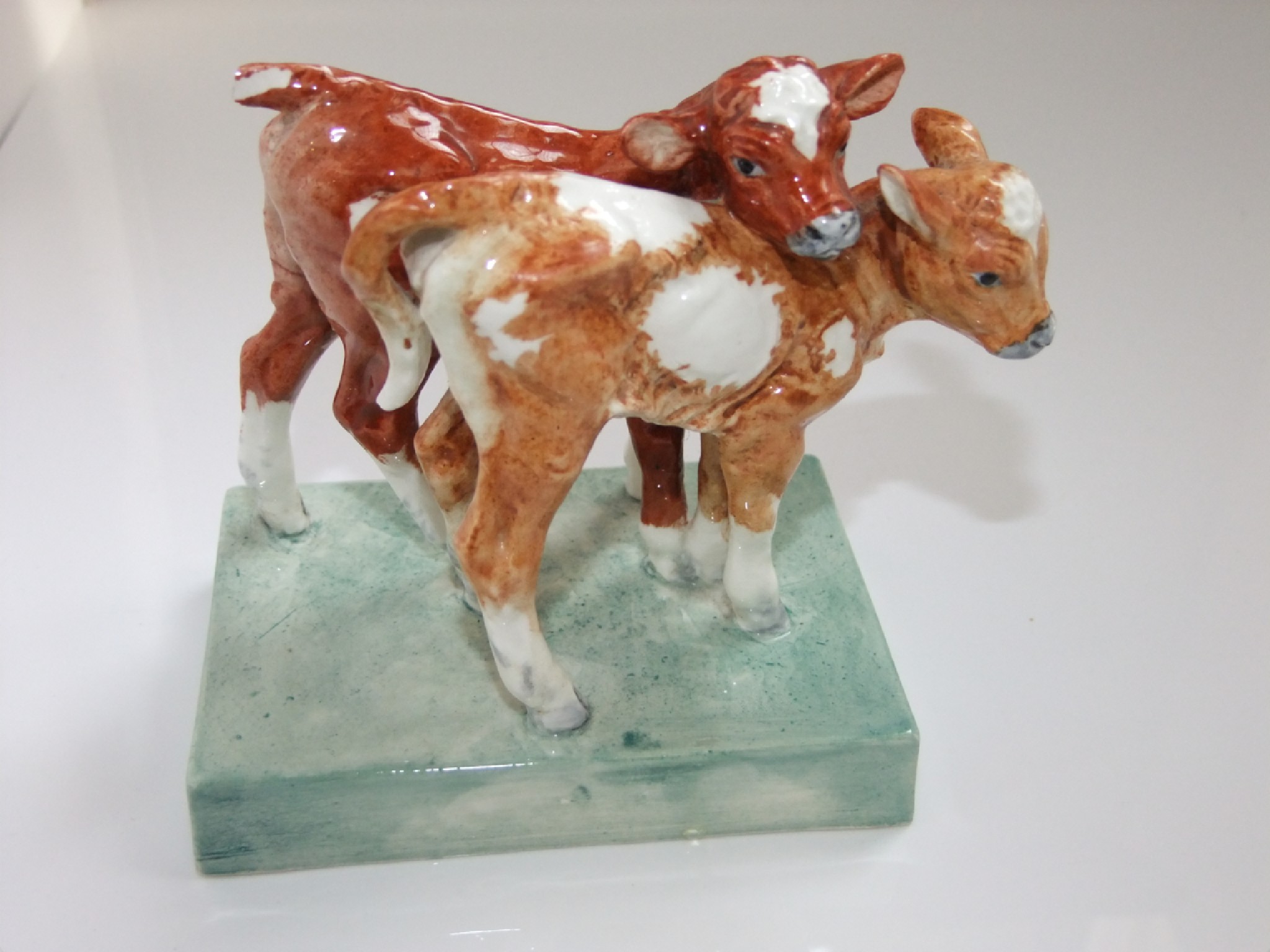 Appraisal: A Royal Worcester group of two calves modelled by Doris