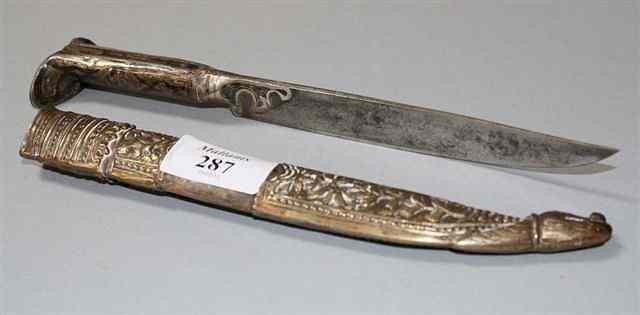 Appraisal: A MIDDLE EASTERN DAGGER with wooden sheath decorated with metal