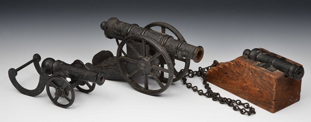 Appraisal: THREE BRONZE TABLE TOP CANNONS one on a wooden carriage