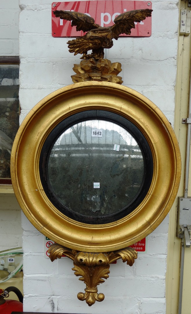 Appraisal: A th century gilt framed convex wall mirror with eagle